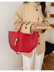 Red woven leather tote bag with hollow design, large capacity shoulder bag for commuting.