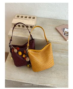 Retro woven shoulder bucket bag for women, stylish casual commuting underarm handbag fashion.