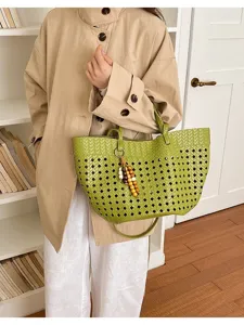 Green woven tote bag detail showing perforated texture, stylish shoulder strap and cute wooden bead charm.