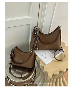 Vintage brown hobo shoulder bag for women, textured fabric crossbody bag with chic strap.