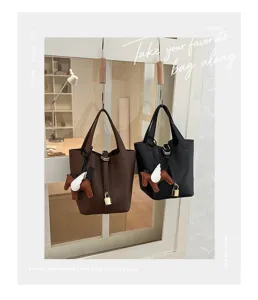 Stylish leather bucket bag with top handle, classic design, versatile shoulder bag.