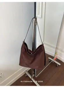Detail view of dark brown suede hobo shoulder bag, soft texture and large capacity daily style.