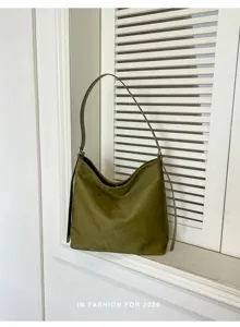 Olive green faux suede hobo shoulder bag detail view in minimalist interior setting