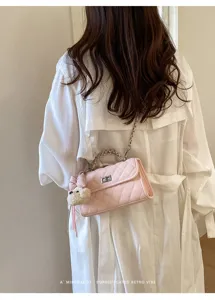 Pink quilted shoulder bag with chain handle and cute bear charm, elegant retro style for women.