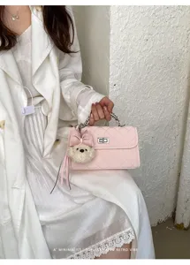 Chic pink quilted chain shoulder bag for women, elegant small square crossbody purse.