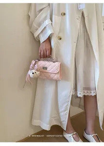 Chic pink quilted handbag with chain handle and cute puppy charm for women daily fashion.