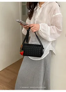 Woven underarm shoulder bag for women, stylish casual leather handbag with knot strap and charm.