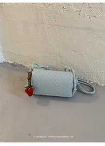 Woven underarm shoulder bag for women, chic retro style leather crossbody bag with charm.