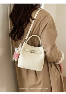 Korean style lychee pattern commuter bucket bag with metal lock and cute rabbit plush pendant.