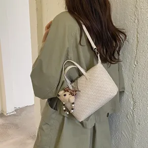 Chic woven dumpling bag for women, stylish crossbody handbag for daily commute and autumn fashion.