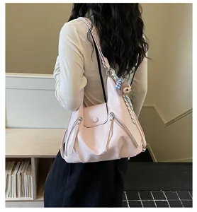 Pink multifunctional women shoulder bag, detail view showing soft leather and pockets.