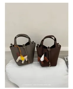 Korean style minimalist retro bucket bag with winged horse charm, premium leather shoulder bag.
