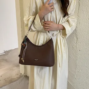 Brown vintage hobo shoulder bag for women, stylish underarm handbag on model view.