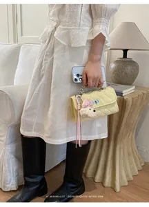 Detail view of a chic quilted chain handbag in a stylish lifestyle setting, elegant retro vibe.