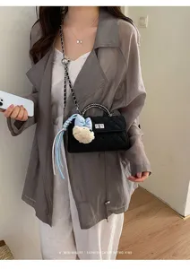 Black quilted chain shoulder bag for women, classic crossbody handbag with cute bear charm.
