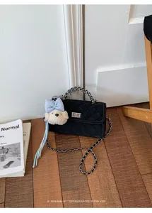 Chic black quilted chain handbag detail, elegant retro shoulder bag with cute bear charm.