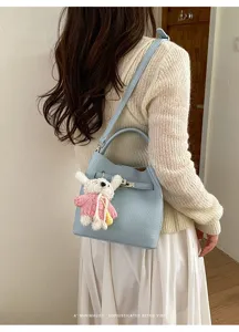 Light blue litchi pattern bucket bag detail, fashion commuter shoulder crossbody handbag style.