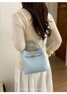 Light blue litchi pattern leather bucket bag, stylish commuter shoulder and crossbody bag.