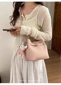 Korean style litchi pattern commuter bucket bag with metal lock and cute knitted bear charm.