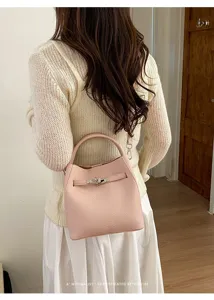 Detailed view of the stylish litchi pattern bucket bag worn on shoulder, elegant daily look.