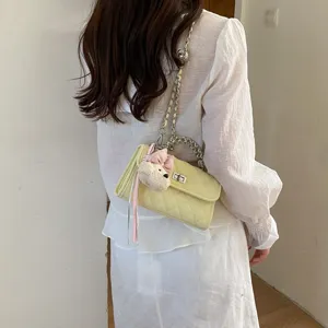 Women yellow quilted shoulder bag with chain strap and cute plush charm, back view product main image