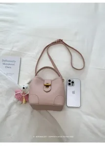 Borsa a secchiello minimalista in pelle rosa con manico e tracolla per donna dettaglio.