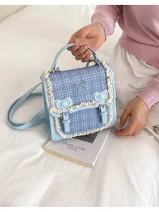 Detailed view of the light blue plaid crossbody bag featuring delicate lace trim and cute bows.