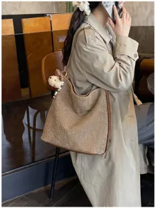 Grande borsa a tracolla intrecciata da donna, borsa a secchiello in paglia con ciondolo.