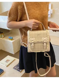 Sweet plaid backpack with bow and lace trim, stylish multi-use shoulder bag for daily wear.