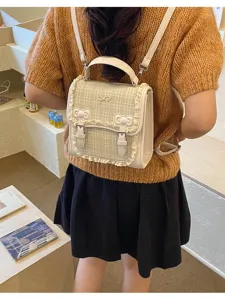 Detailed shot of sweet plaid mini backpack with cute bows and delicate lace trim design.