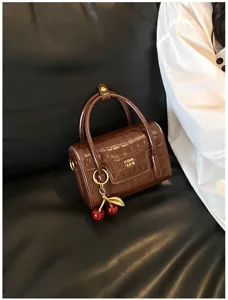 Brown crocodile pattern handbag with cherry charm, stylish small crossbody bag for women daily.