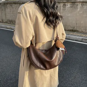 Retro brown PU leather hobo shoulder bag for women, casual large capacity crescent crossbody bag.