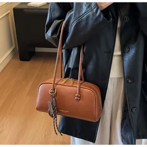 Retro brown leather bowling bag, stylish casual shoulder pillow bag for women's daily commute.