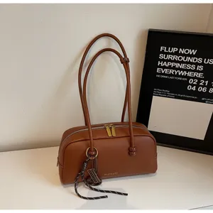 Vintage brown bowling shoulder bag with double straps and zipper for women daily commute use.