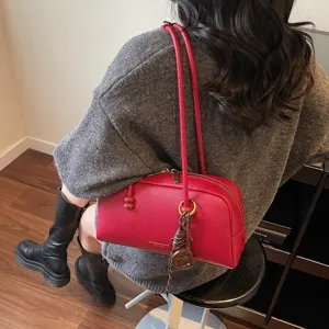 Minimalist retro bowling bag for women, stylish casual shoulder bag with dual top handles.