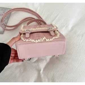 Pink plaid backpack detail view showing sweet lace trim, metal buckles and quality PU leather.