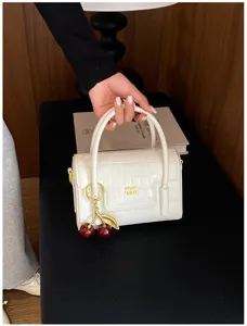 White crocodile texture handbag with cherry charm, stylish PU leather crossbody bag.