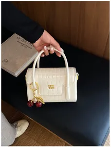 Elegant white crocodile pattern mini handbag with cute cherry charm for women daily fashion.