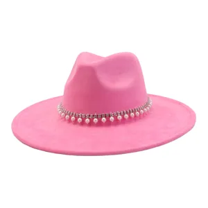 Close-up detail of the pink suede fedora hat, featuring elegant rhinestone and pearl band.
