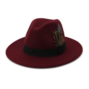 Close-up view of the wine red wool fedora hat featuring a black band and feather accent.