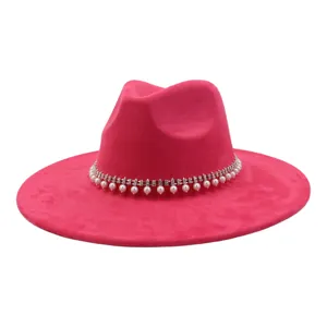 Detailed view of hot pink fedora hat with rhinestone pearl band, stylish autumn winter headwear.