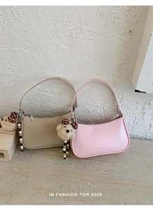 Chic small shoulder bag and underarm bag detail, featuring cute bear plush charm and beads.