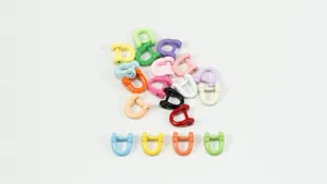 Close-up detail shot of colorful metal horseshoe shackles and D-rings for DIY crafts.