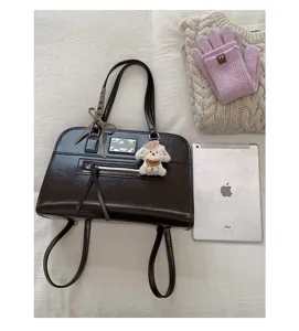 Retro dark brown oil wax leather Boston handbag with cute puppy charm and shoulder straps.