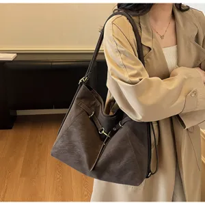 Retro brown multi-use tote bag detail showcasing fine leather texture and metal buckles.
