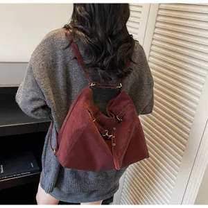 Detailed close-up view of women's retro multi-way shoulder and backpack in burgundy style.