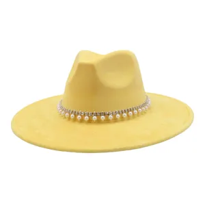 Yellow suede fedora hat detail, elegant pearl and rhinestone band, stylish autumn headwear.
