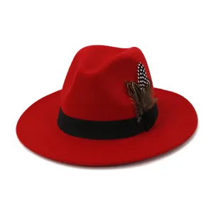 Red wool felt fedora hat with black band and feather decoration, classic western fashion hat.