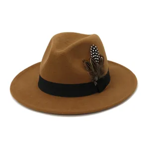 Close-up view of the brown wool felt fedora hat featuring a black band and feather accent.
