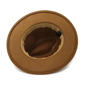 Detailed view of brown wool fedora hat, flat brim jazz hat with inner sweatband and label.